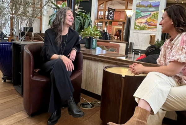 Monika Anderson meeting with a client to discuss small business marketing strategy